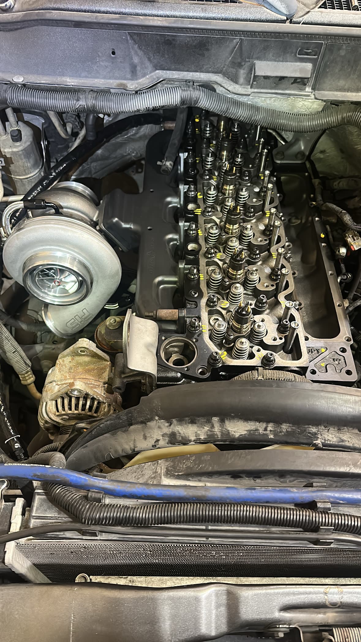 Diesel engine components laid out on a workshop bench