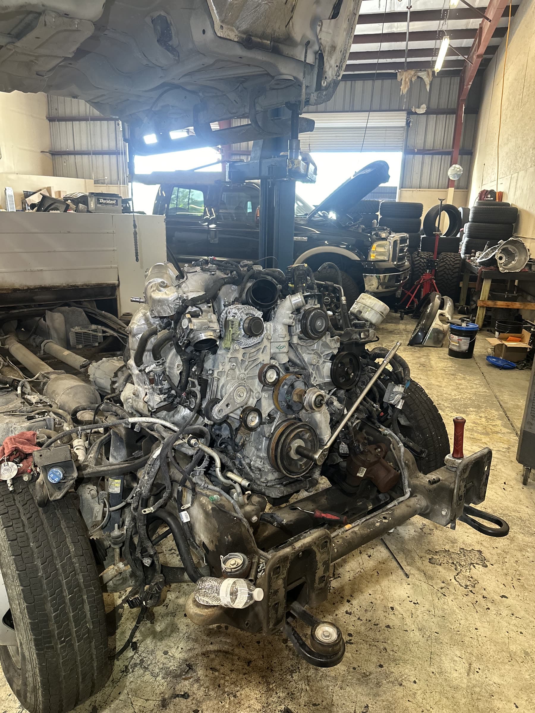 Diesel engine removal and rebuild work in a workshop